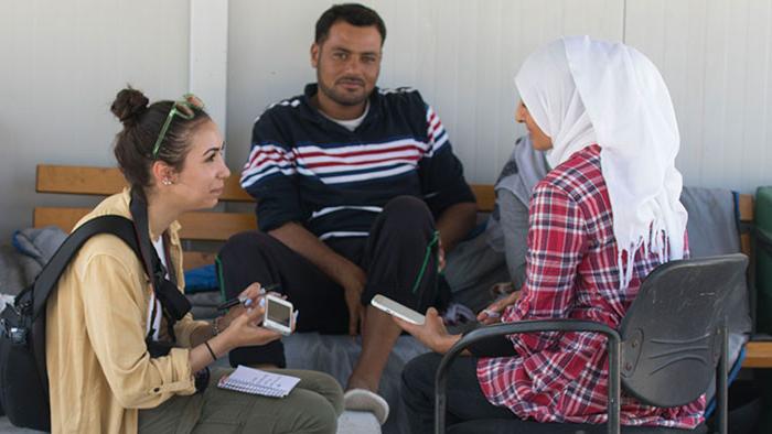 Student interviewing refugees in Greece.