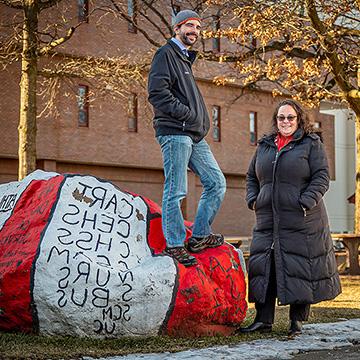 Julie Fleming and Anthony Mennuti pose with a painted rock