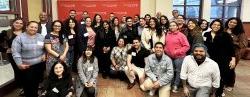 Large group poses for photo at Hispanic networking event.