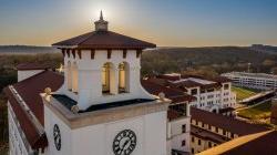 aerial photo of university hall bell tower at golden hour