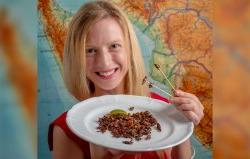 Photo of Cortni Borgerson with bugs on a plate