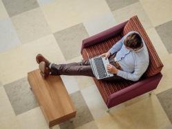 Student sitting in lounge with laptop