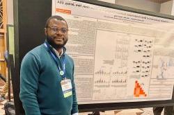 Oluwafemi Soetan with poster at a conference