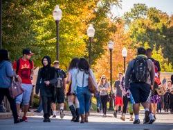Students walking around in the spring on a main road in Montclair State.