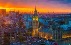Photo of sunset over london with Big Ben and surrounding buildings lit up.